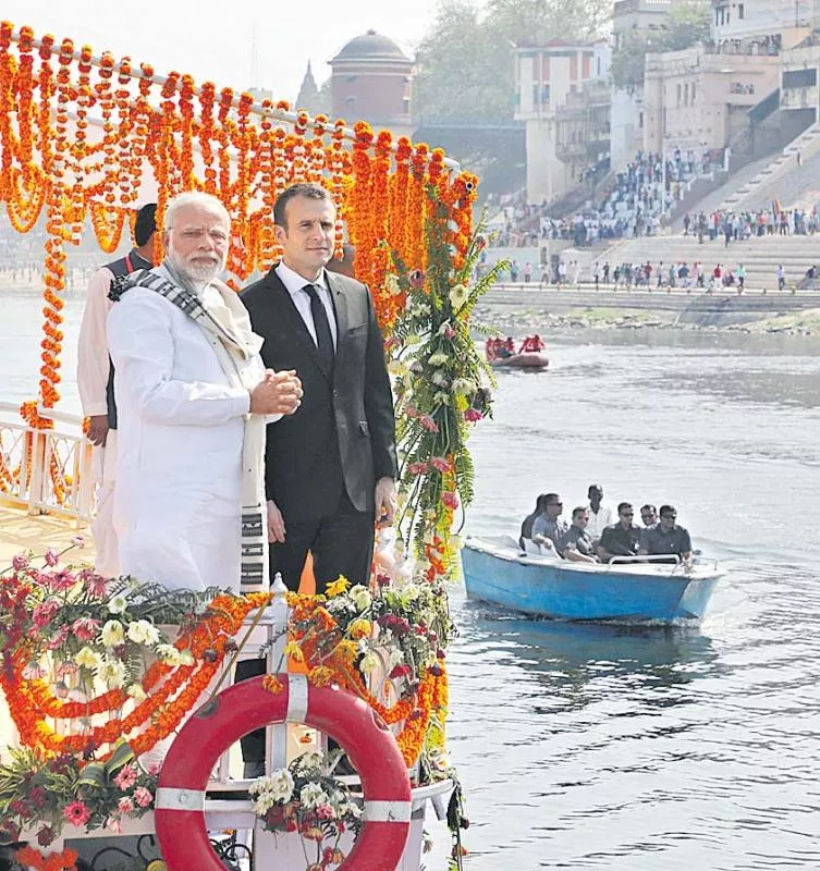 PM Narendra Modi, French President Emmanuel Macron take Varanasi boat ride - Sakshi