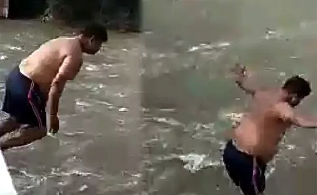 Man Jumping In Full Flow River Karnataka - Sakshi